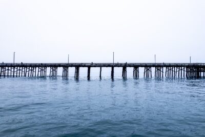 A wooden pier extending over the Pacific Ocean in Newport Beach, California